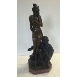 A large bronze ornament of a nude lady with an arab slave trader, set on a marble base. Approx