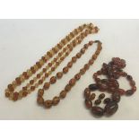 3 vintage amber coloured necklaces, 2 glass and one c1930s plastic/bakelite (needs re-stringing).