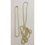 2 strands of faux pearls. First 54 inches long and second 24 inches long.