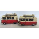 A pair of tin plate campervans for decorative use.