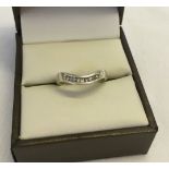 A 9ct white gold ring with 9 channel set diamonds. Size K, total weight approx 1.9g