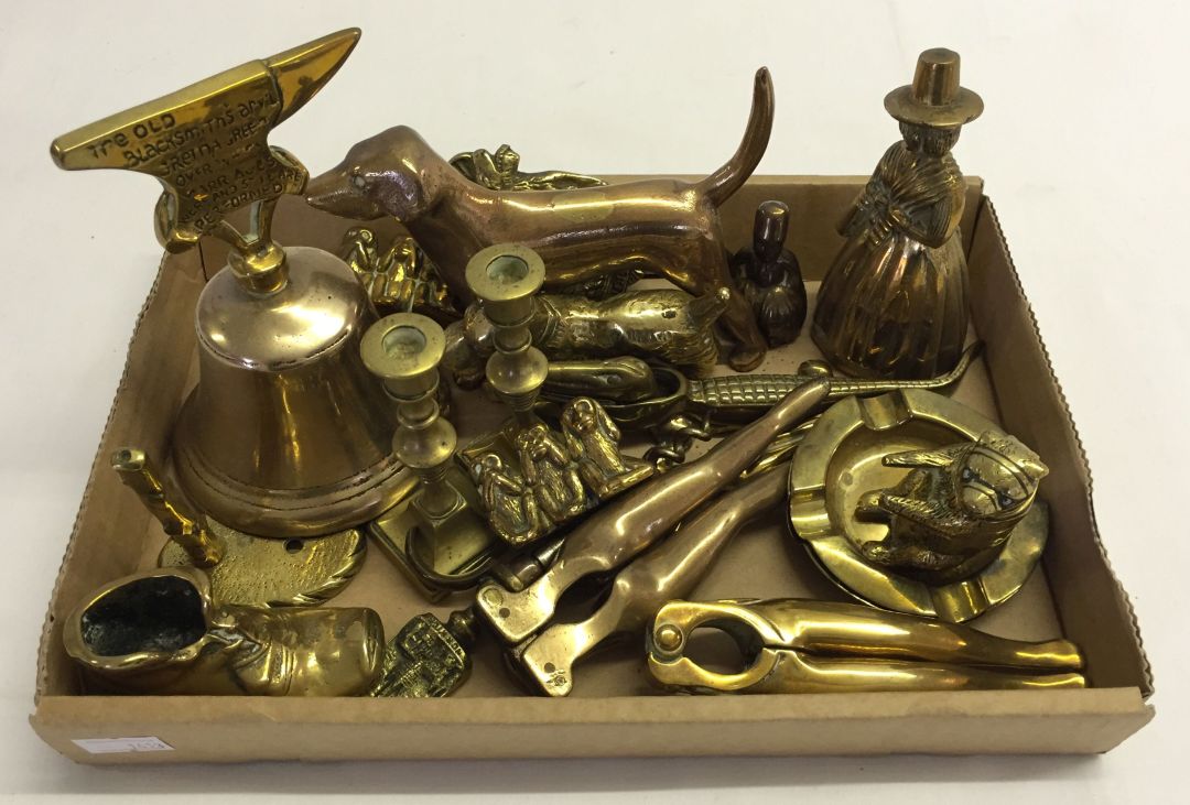 A quantity of small brass items to include: nutcrackers, bells & brass dog ornaments.