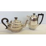 A silver plated coffee pot and hot water pot with wooden handles and knobs