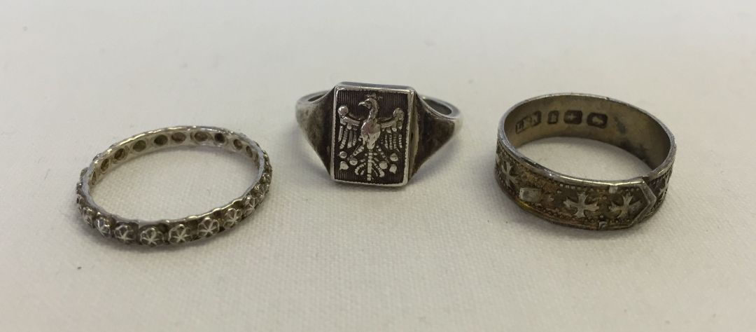 3 silver rings one hallmarked Birmingham 1884 & one with an Eagle motif.