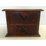 A mahogany 2 drawer table top cabinet with patterned veneer front to drawers, approx 28x21cm