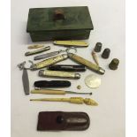 A small box of misc items to include penknives, thimbles & hat pins.