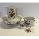 A ceramic bathroom set with bird & flower design comprising jug & bowl, chamber pot, toothbrush