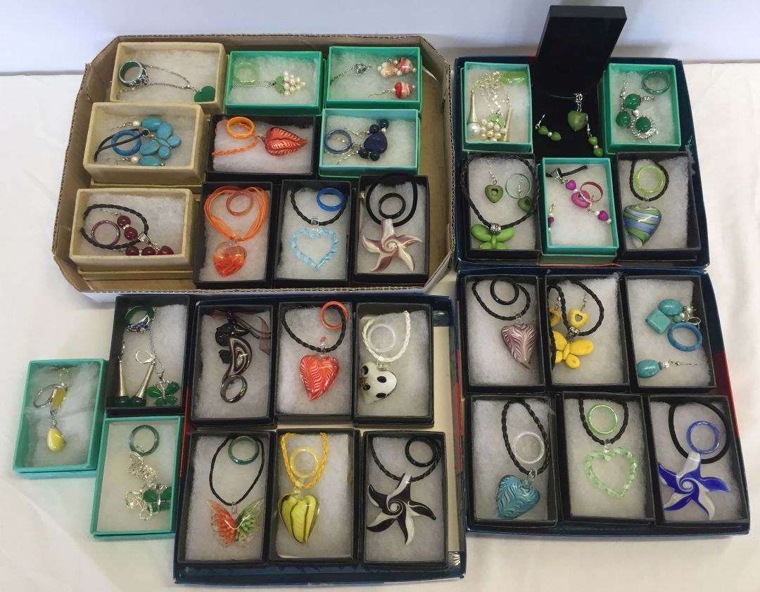 A collection of 31 jewellery sets with glass and gemstone beads.