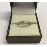 A 9ct white gold channel set diamond eternity ring size O.