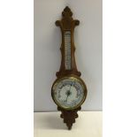 An antique wooden wall hanging barometer with carved decoration presented to Supt. P. Palmer in