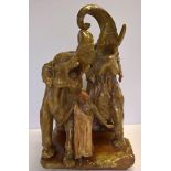 A very large continental ceramic figurine depicting elephants & trainer approx 40 x 63cm.