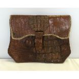 A crocodile skin ladies clutch bag with soft leather interior.