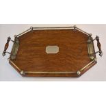 An octagonal wooden tray with silver plate gallery and detail to handles.