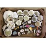 A box of ceramic commemorative items together with a quantity of lidded trinket pots.