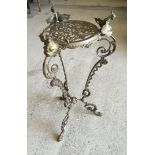 An ornate brass side table / plant stand with classical design dolphin decoration