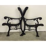 A pair of black cast iron bench ends