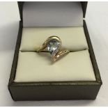 Unusual design blue topaz & diamond ladies ring. Large pear cut stone approx 0.75ct. Hallmarked