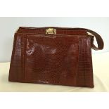 A vintage lizard skin ladies handbag with lovely soft leather interior.