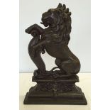 A vintage cast iron doorstop in the shape of a Lion