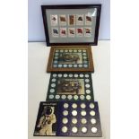 A framed and glazed set of Shell petrol historic car coins with two other sets of coins on card,