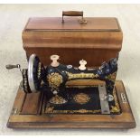 A vintage Jones sewing machine in wooden case.