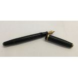 A black Parker Duofold fountain pen with 14ct gold nib.