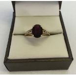 9ct gold ring set with an oval garnet. Weight approx 2.2g, size P.