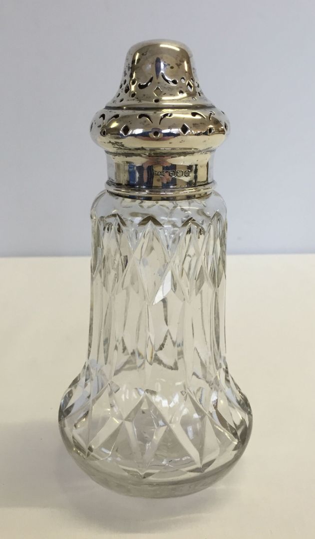 A silver topped lead crystal sugar sifter by Walker & Hall. Hallmarked Sheffield 1920.