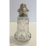 A silver topped lead crystal sugar sifter by Walker & Hall. Hallmarked Sheffield 1920.