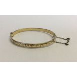 A 9ct rolled gold bangle.