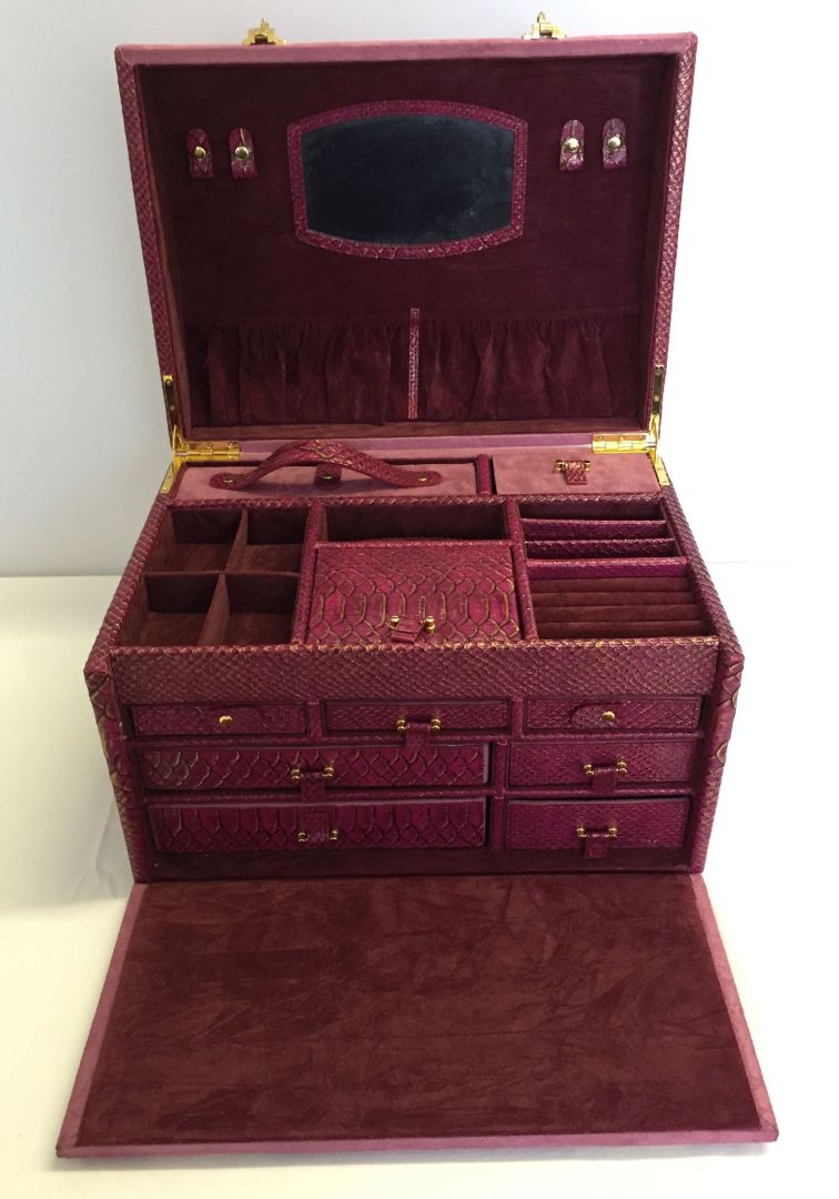 A large lockable 'Beauty Box' ladies jewellery and beauty case in pink suedette and snakeskin