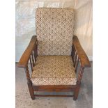 An early 20th century dark oak reclining nursing chair with barley twist columns. Tapestry design