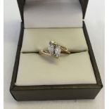 9ct gold ring set with 2 clear stones in a cross over mount. Weight approx 2.4g, size L1/2.