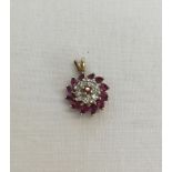 9ct gold pendant set with rubies and diamonds. Total weight approx 1.7g. Approx 1.4cm across x 2cm