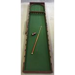 A Victorian fold-up billiard style bagatelle table with later cue and 3 boxed balls.