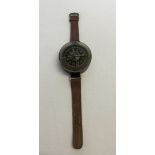 German WW2 Luftwaffe arm band compass, black bakelite with brown leather strap. Reverse marked