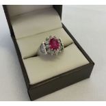 9ct white gold ladies ring set with central pink stone surrounded by clear stones. Weight approx 4.