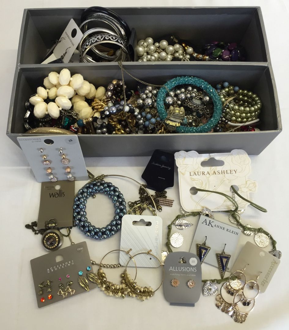 A box containing a large quantity of quality costume jewellery. Some still on cards.