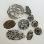 A collection of pewter jewellery comprising 6 brooches, earrings and a pendant. To include Justin