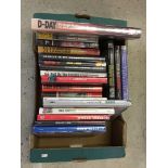 A box of military hardback books.