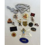 A bag of assorted modern badges with a 'Superman' belt buckle.