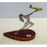 A small brass aeroplane mounted onto a wooden plinth with RAF coat of arms.