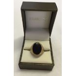 A gents 9ct signet ring with black onyx oval stone. Size S. Total approx weight 5.3g