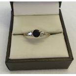 9ct gold ring set with a central sapphire and 2 cubic zirconias. Weight approx 1.5g. Size U.