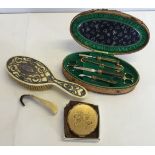 A small collection of vintage ladies items comprising: a manicure set, a Stratton compact, a horn