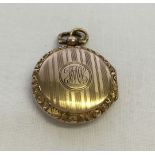 9ct engraved locket. Hallmarked Birmingham 1863, total weight approx 5.9g. 2.75cm diameter.