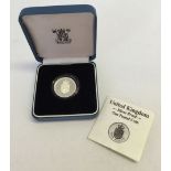 A cased silver proof British £1 coin.