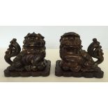 A pair of Chinese carved wooden dogs of Fo incense burners.