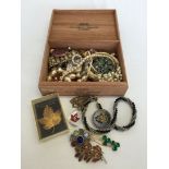 A wooden cigar box (Agio) containing a quantity of vintage costume jewellery.