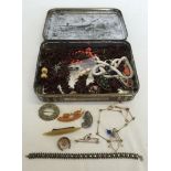 A vintage tin containing antique and vintage costume jewellery.